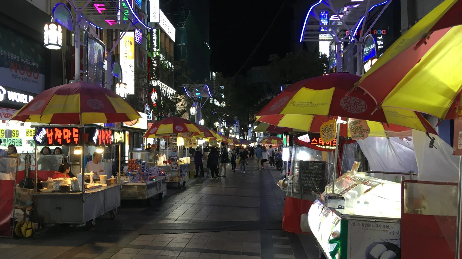 Street-food stalls and illuminated signs in BIFF Square, Busan, at night