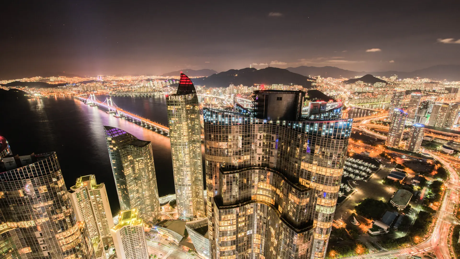 Haeundae and Marine City buildings illuminated above the Busan waterfront at night
